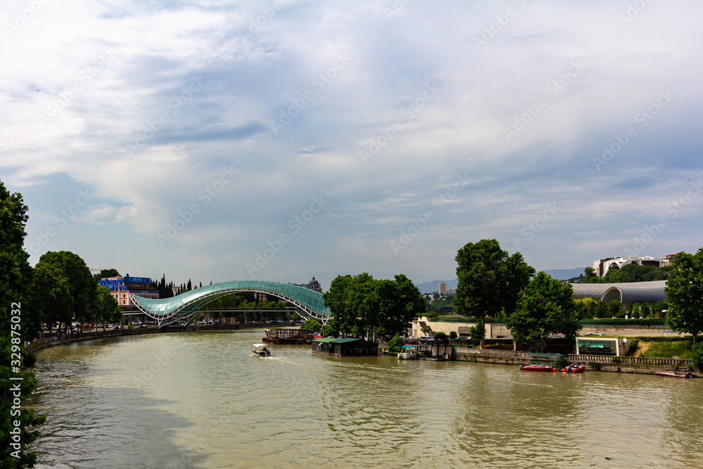 June 21, 2019 - Tbilisi, Georgia - The Bridge of Peace is a pedestrian bridge spanning the Kura River between Old Tbilisi and the new district