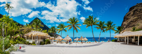 Sugar beach Saint Lucia , a public white tropical beach with palm trees and l...