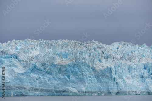 Disenchantment Bay, Alaska, USA: Closeup view of the Hubbard Glacier, under a cloudy sky.