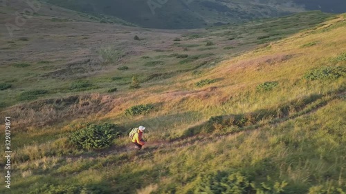 Wallpaper Mural Tourist hiker with a backpack running on mountain path in Carpathian mountains. Man tourist jogging in rocky desert terrain. Torontodigital.ca