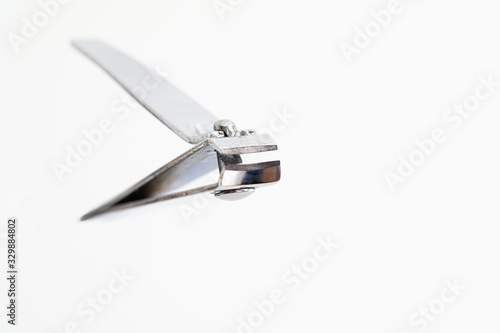 Single metal silver nail clipper macro close up shot isolated against white