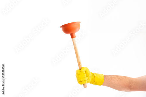 Bild auf Leinwand White Caucasian male hand with yellow latex glove holding a sink plunger against