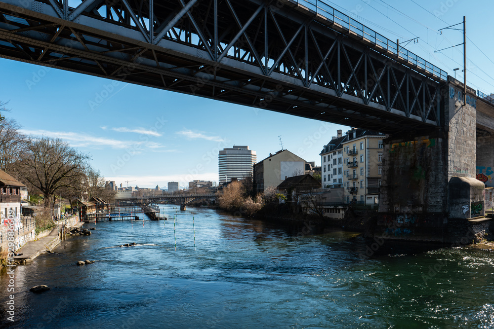 Zurich city view of the Limmat river and industrial buildings and steel bridge in the background sunny day Switzerland.