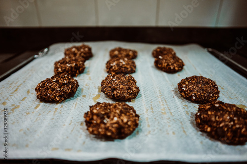 Cooking cookies at home based on healthy ingredients like banana  chocolate and oatmeal. Shaping cookies before putting them in the oven. Lifestyle