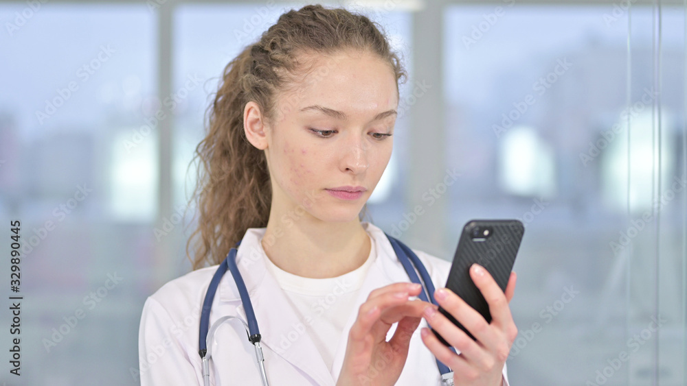 Portrait of Focused Young Female Doctor using Smartphone Portrait of Focused Young Female Doctor using Smartphone