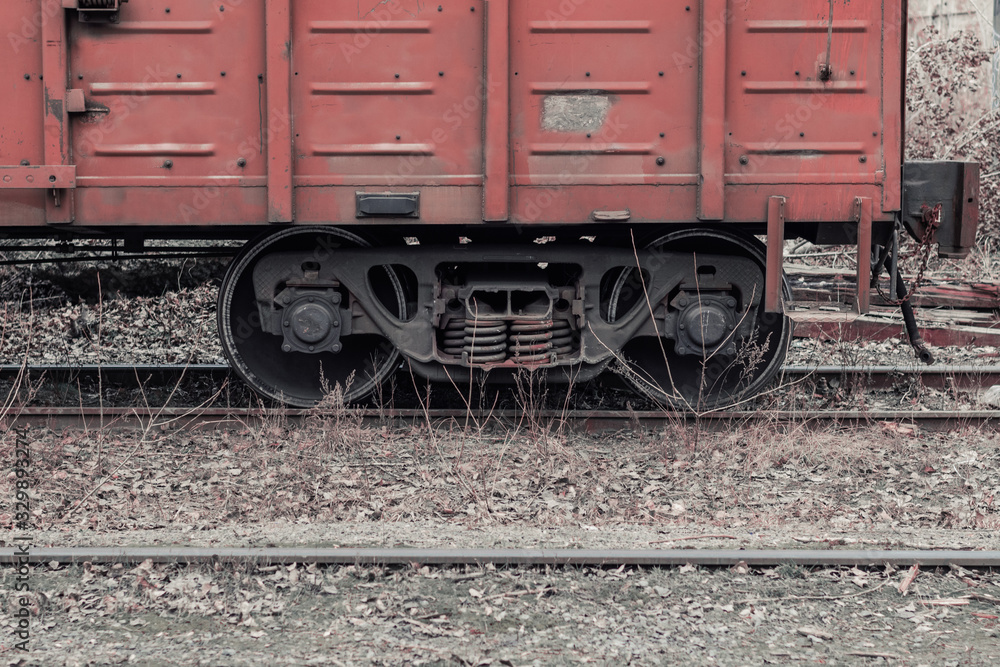 Train wheels. Wagon axle. Freight car on rails. Brown wagon at an abandoned train station Train wheels. Wagon axle. Freight car on rails. Brown wagon at an abandoned train station