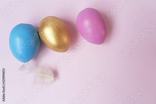 Pink, golden, orange, blue eggs. Copy space. Place for text and design. Top view. Flat layout.