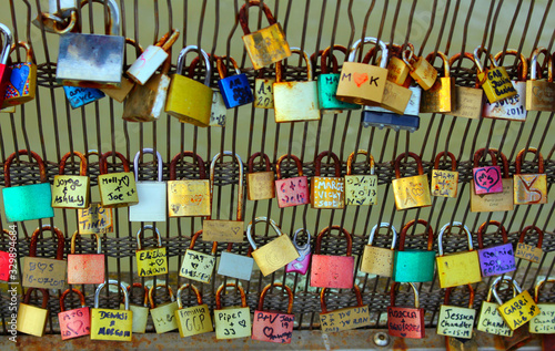View hung with multi-colored locks bridge in Paris. © Алексей Леганьков