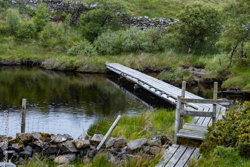 Wooden platform across a bank for fishing from