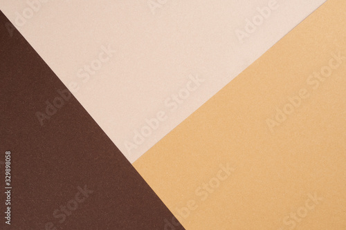 Background from recycled textured paper forming triangular shades of dark brown photo