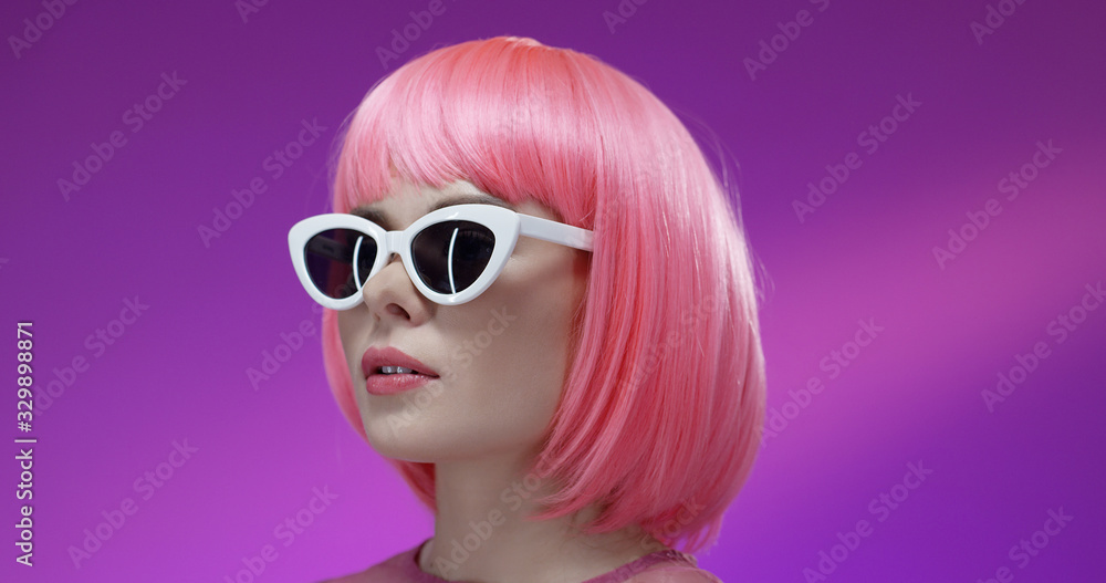 Woman with pink hairstyle wearing retro sunglasses. Woman with pink hairstyle wearing retro sunglasses.