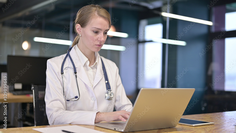Young Female Doctor Working on Laptop in Office Young Female Doctor Working on Laptop in Office