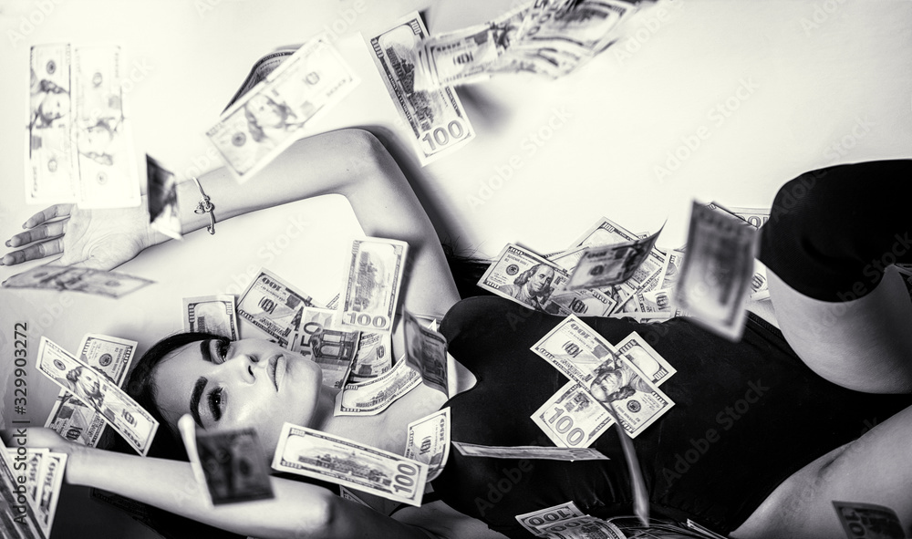 Woman with lot of money. Millionaire woman lying in bedroom. Rich sexy woman lies on money. Sexy woman lying in dollar bills. Black and white