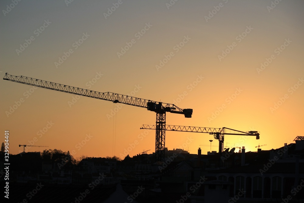 Cranes working at sunset in Lisbon