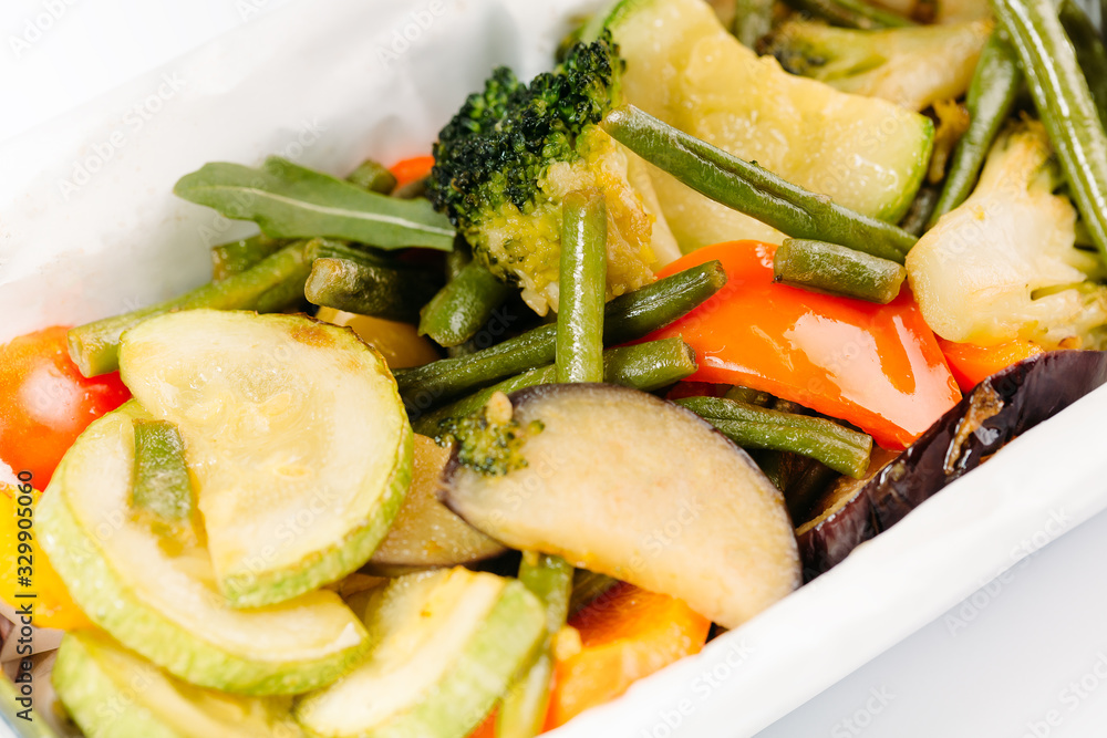vegetarian salad of prepared cabbage, pepper, broccoli and tomato in a box vegetarian salad of prepared cabbage, pepper, broccoli and tomato in a box