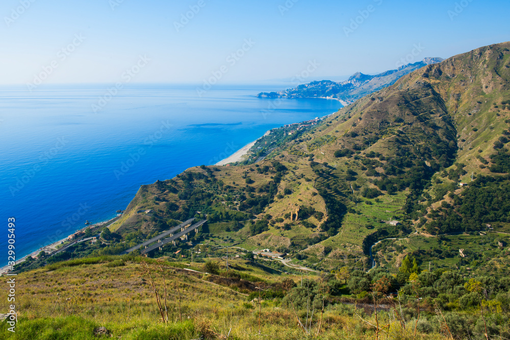 Aerial view along the Sicilian coast from Forza D'Agro of the coast towards Taormina on a sunny day