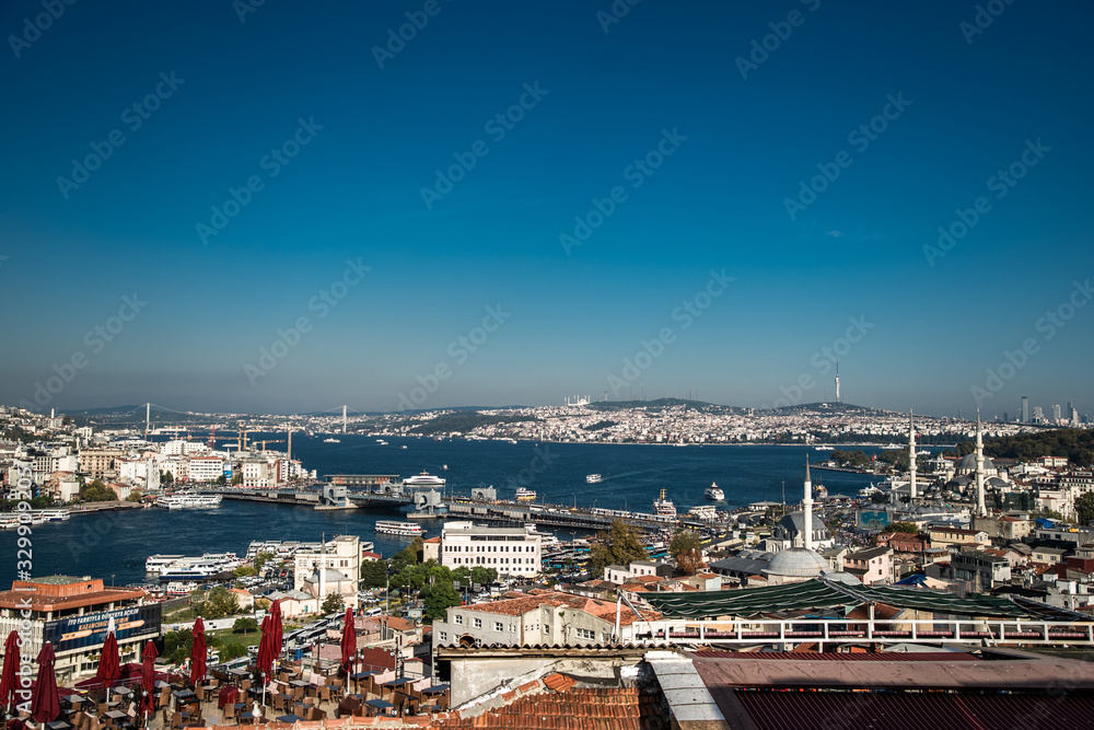 Naklejka premium Bosphorus in Istanbul at sunset, Turkey. Aerial panoramic view of the city divided by Bosphorus. Beautiful cityscape of Istanbul with cruise ships on the nice Bosphorus. 