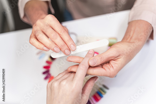 Focused photo on female hands that doing manicure