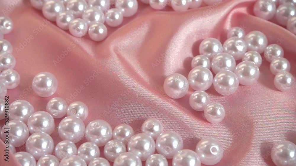 Pearls fall on silk. Slow motion. Pearls fall on silk. Slow motion.