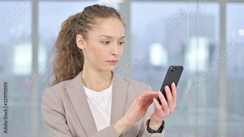Portrait of Young Businesswoman using Smartphone