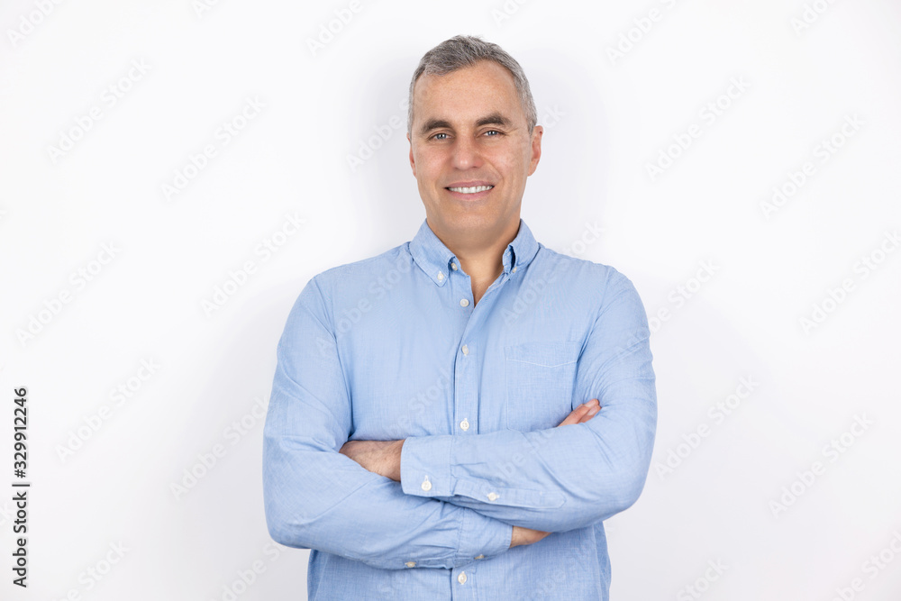 adult handsome man with grey hair wearing blue shirt standing in hand on hand pose on isolated white background, looks confiden adult handsome man with grey hair wearing blue shirt standing in hand on hand pose on isolated white background, looks confiden