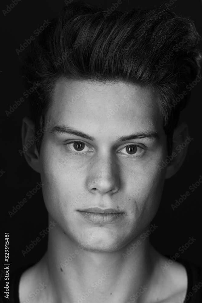 Obraz premium Portrait of a young handsome dark haired man with a fan