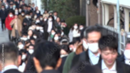 Wallpaper Mural TOKYO, JAPAN -MARCH 2020 : Crowd of people walking down the street in morning rush hour. Many commuters going to work. People wearing mask to protect from Coronavirus(COVID-19) or cold. Blurred shot. Torontodigital.ca