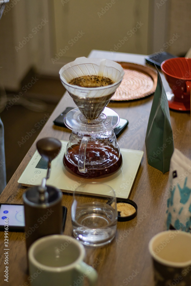 Devices for Alternative coffee brewing. Transparent glass pour over dripper with paper filter Devices for Alternative coffee brewing. Transparent glass pour over dripper with paper filter