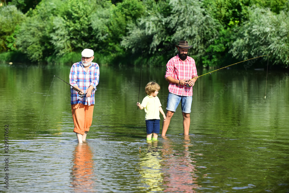 Family generation and people concept. Little boy on a lake with his father and grandfather. Family generation and people concept. Little boy on a lake with his father and grandfather.