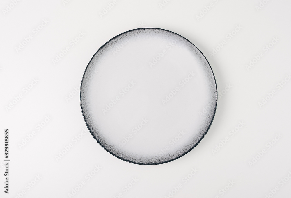 Empty white ceramic round plate isolated on white background Empty white ceramic round plate isolated on white background