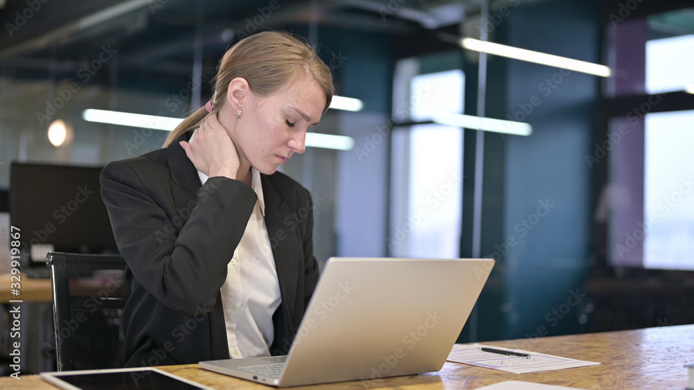 Young Businesswoman having Neck Pain in Office Young Businesswoman having Neck Pain in Office