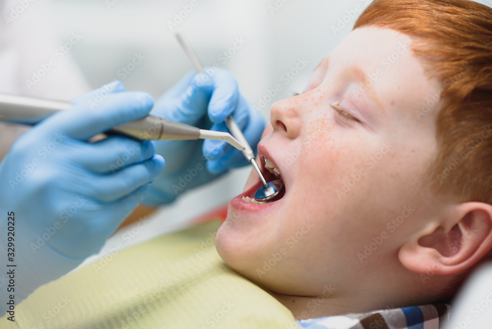 Female dentist and child in a dentist office Female dentist and child in a dentist office