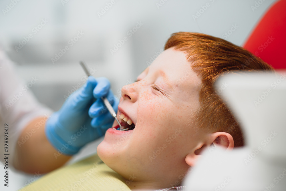 Female dentist and child in a dentist office Female dentist and child in a dentist office