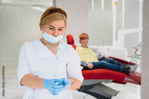 Portrait of a dentist holding dental instruments in his hands in the clinic close-up