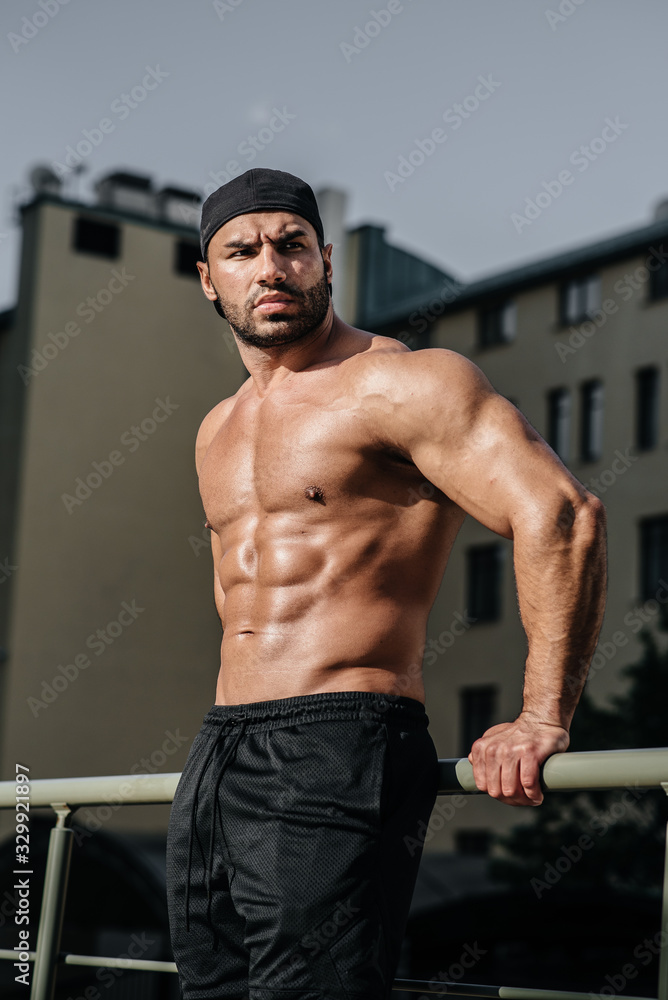 Fototapeta premium Sexy athlete sucks and poses topless. Europe.