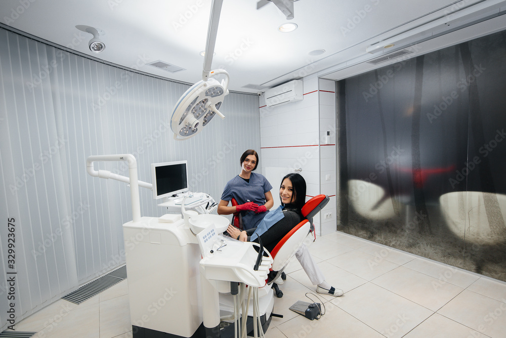 Fototapeta premium Doctor and patient look at the camera, smile health. Dentistry