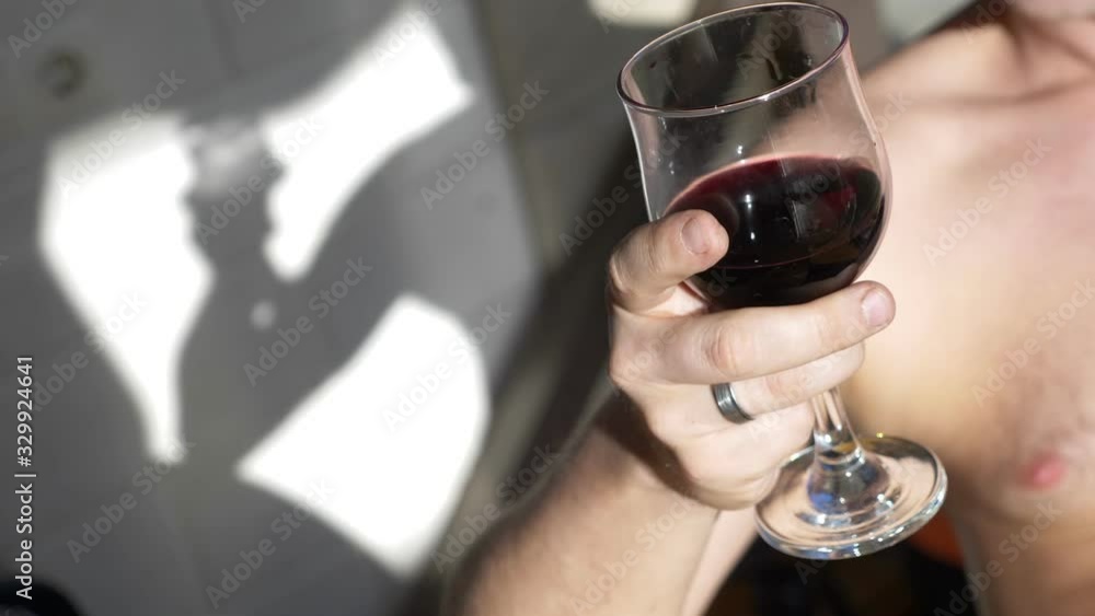 closeup. a glass of red wine in the hand of man . party in the backyard closeup. a glass of red wine in the hand of man . party in the backyard