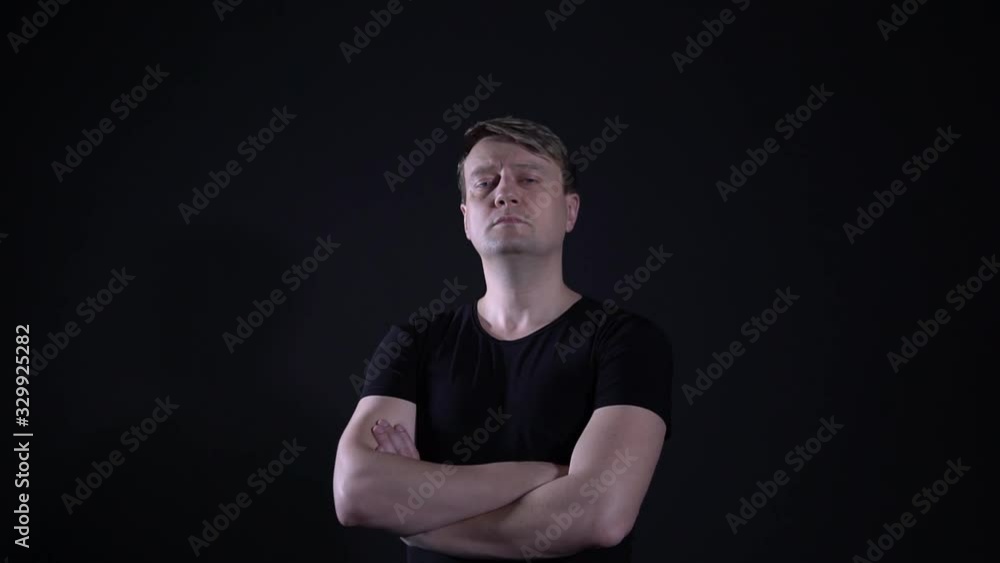 A man looks handsome to us, arms crossed