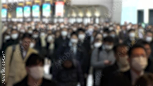 Wallpaper Mural TOKYO, JAPAN - MARCH 2020 : Crowd of people walking at Shinagawa station in morning rush hour. Many commuters going to work. People wearing mask to protect from Coronavirus(COVID-19). Blurred shot. Torontodigital.ca