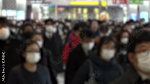 Wallpaper Mural TOKYO, JAPAN - MARCH 2020 : Crowd of people walking at Shinagawa station in morning rush hour. Many commuters going to work. People wearing mask to protect from Coronavirus(COVID-19). Blurred shot. Torontodigital.ca