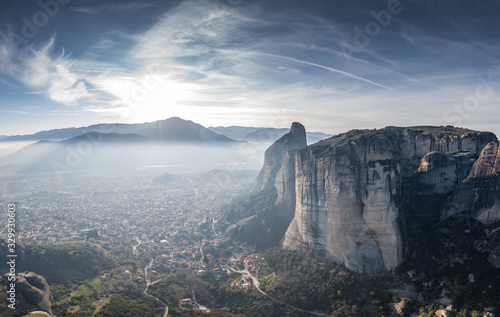 Aerial view of Unesco monument Meteora, the mountains, the landmark of Greek, sunny weather, fog, haze over a valley