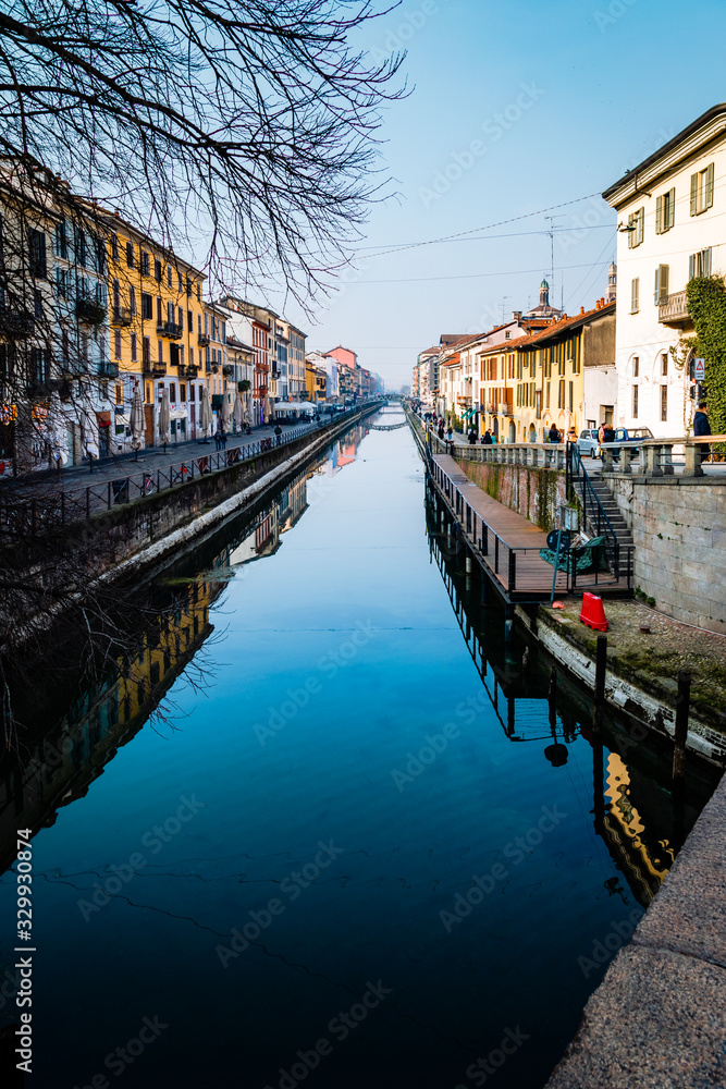Milan, Navigli (Darsena) people walking on the banks of the canal on a sunny winter day