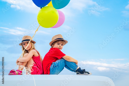 Children on countryside on sky background isolated. Little boy with little girl - kids couple in love. Funny kids, Valentines Day.