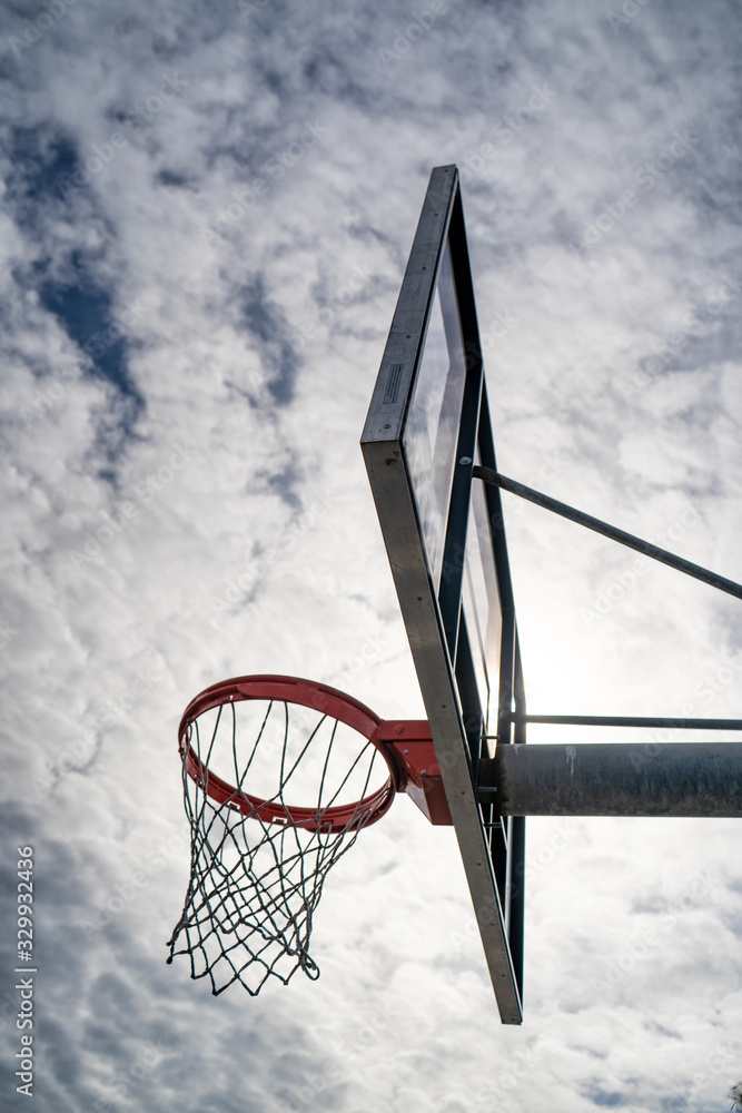 Outdoor basketball rim on a cloudy day Outdoor basketball rim on a cloudy day