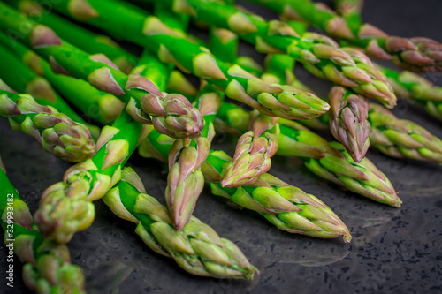 green fresh asparagus on black background photo