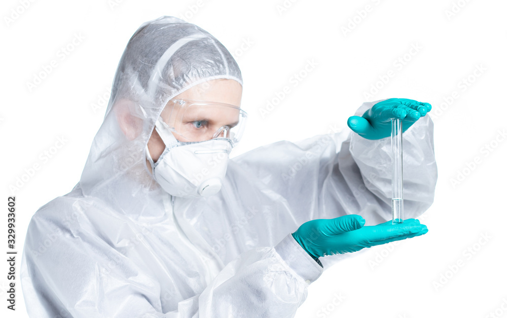 The epidemic of the Chinese coronavirus. Biological hazard. A man in a protective suit and mask holds a tube. Flu vaccine, coronavirus, ebola. Isolated The epidemic of the Chinese coronavirus. Biological hazard. A man in a protective suit and mask holds a tube. Flu vaccine, coronavirus, ebola. Isolated