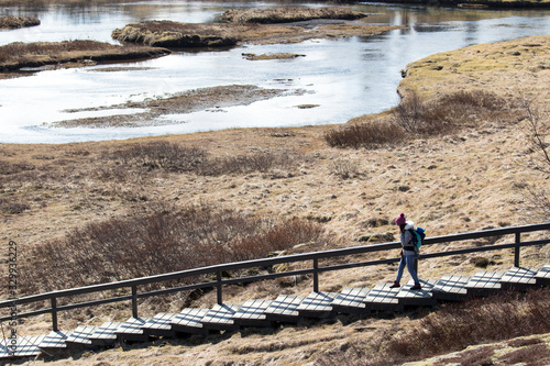 woman with backpack on a stair in a wilderness