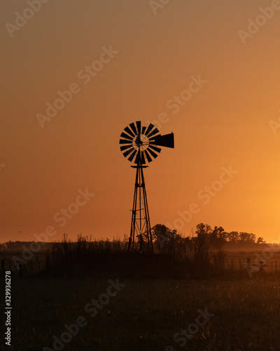 Silhouette of a windmill at a golden sunset