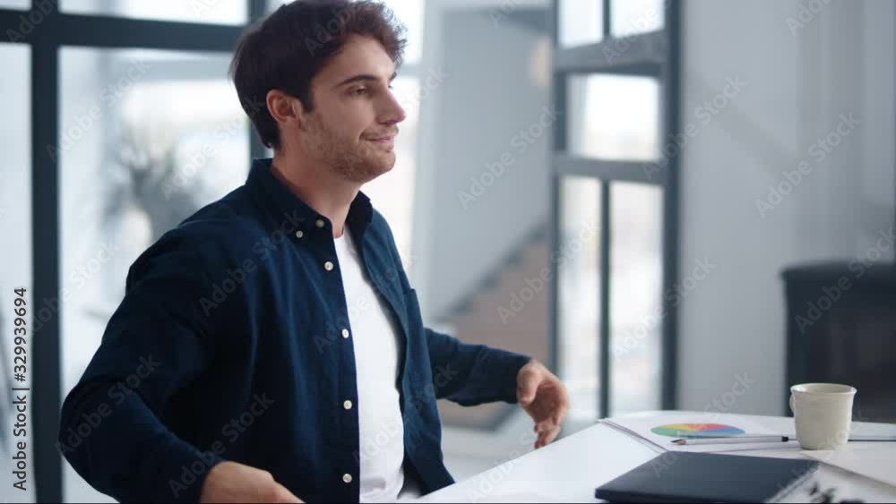 Happy business man finishing work on laptop indoor. Man meditating near computer Happy business man finishing work on laptop indoor. Man meditating near computer