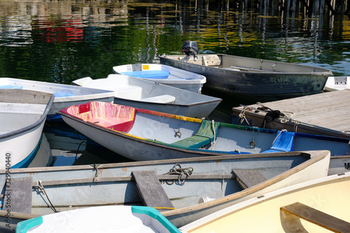 Wallpaper Mural Docked small rowboats and skiffs tied together on a calm and peaceful Coastal Maine dock and Harbor Torontodigital.ca